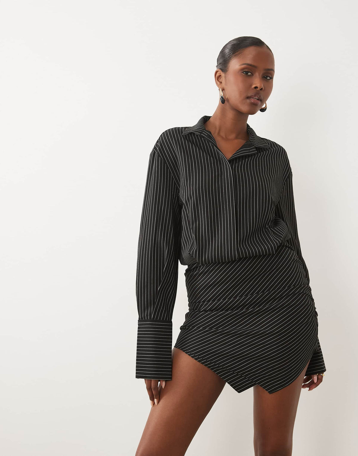 Noughts & Kisses cotton rich button up asymmetric hem deep cuff mini shirt dress in black pinstripe
